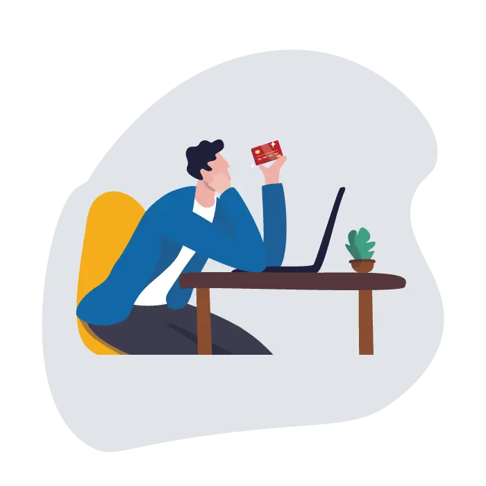 Man sitting behind a table, holding a payment card