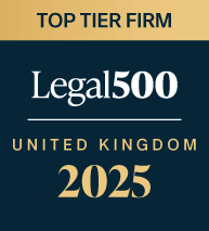The logo has dark blue and golden background consisting of three sections written in dark blue, white and gold. The first section has typed top tier firm in capital letters. The second section states "Legal500". The third section says "United Kingdom 2025"